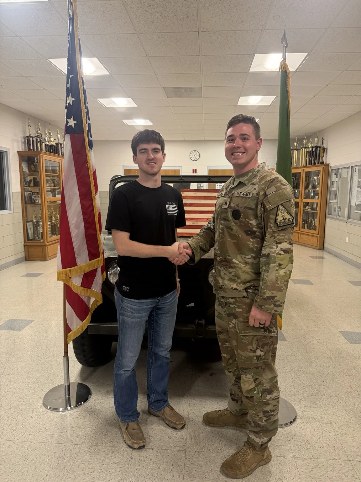 SGT Barks shaking hands with a student at a school